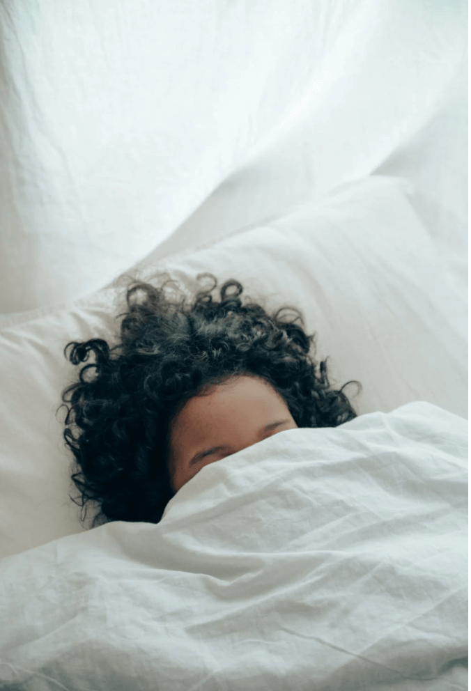 person sleeping under blanket