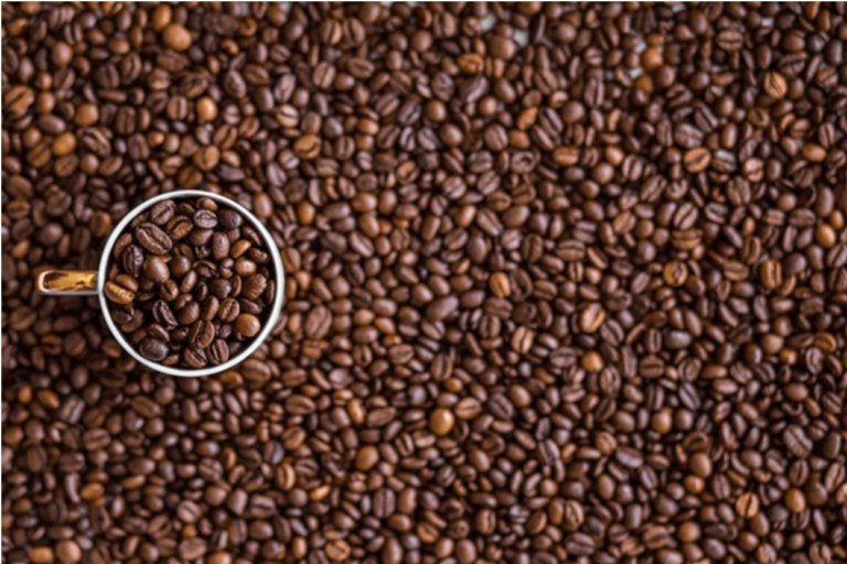 white mug containing coffee beans