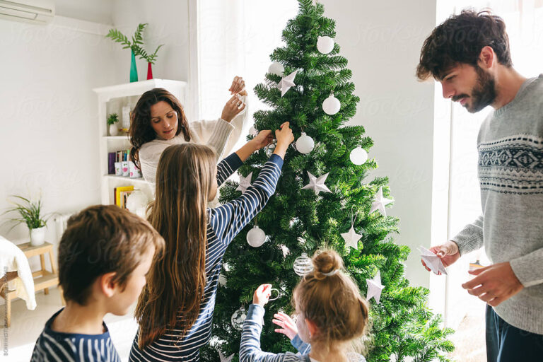 Family decorating Christmas tree