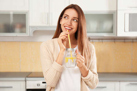 woman drinking lemon water