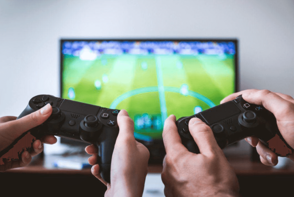 2 hands holding gaming consoles and playing football
