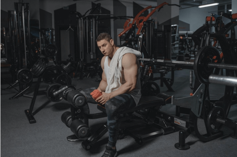 A bodybuilder drinking a protein supplement for fat and weight loss