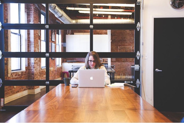 Woman working on the laptop and submitting a proposal.