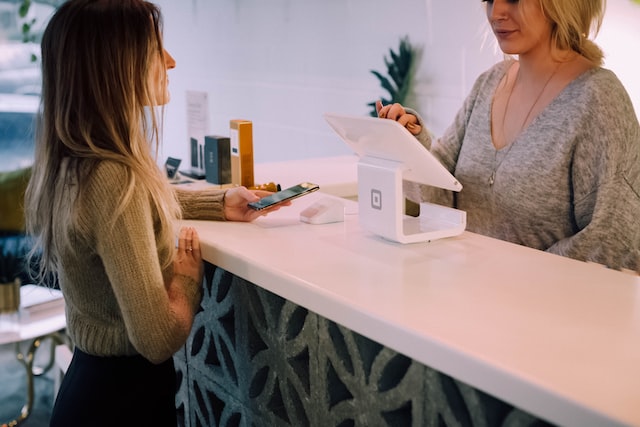 A woman making a payment on the POS system.