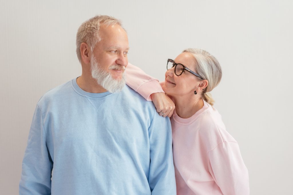 A woman holding a man's shoulder and looking into his eyes.