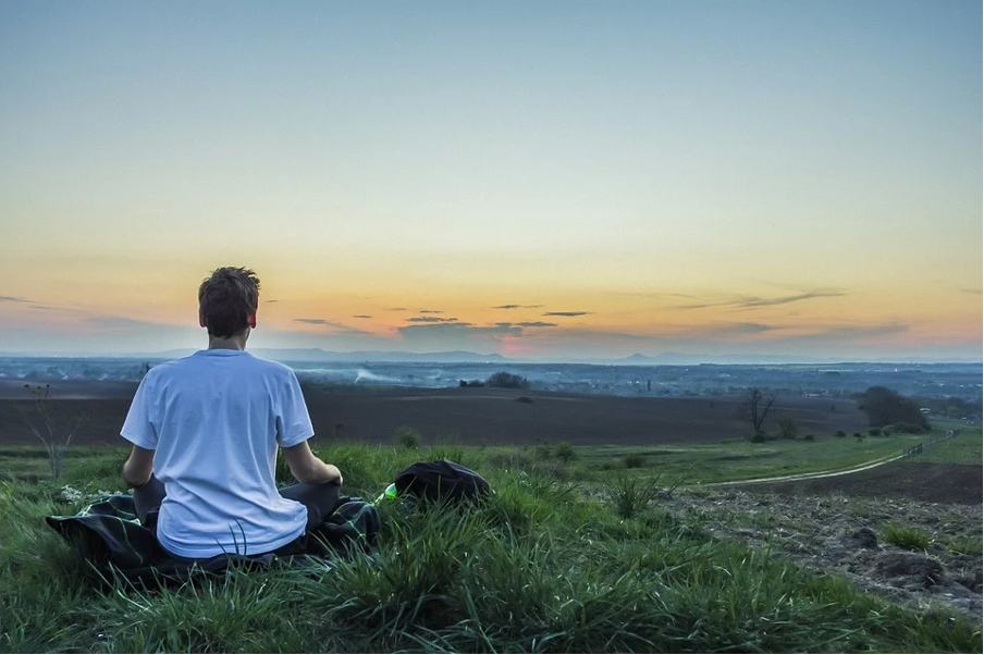 A man meditating in the dawn.