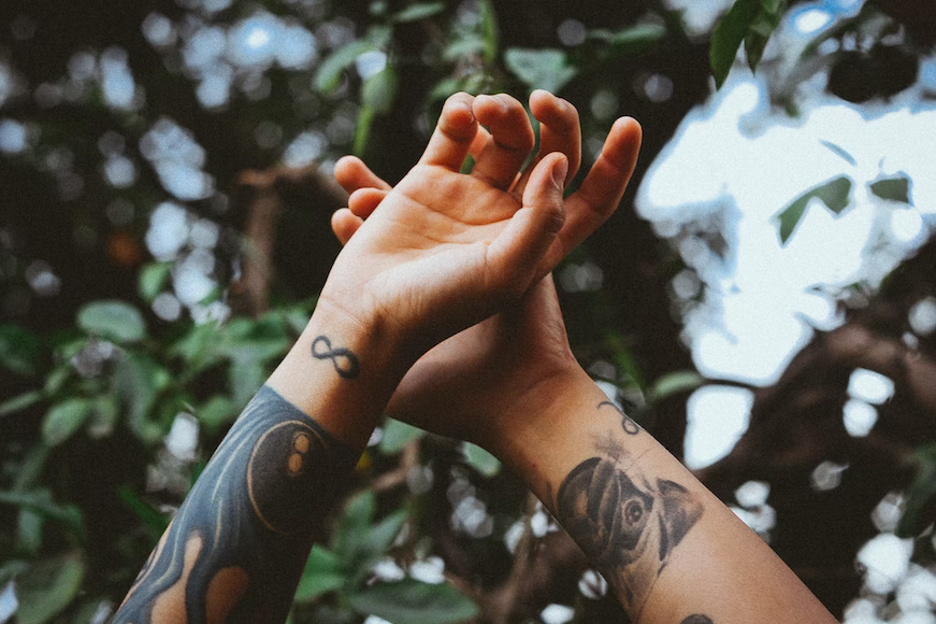 A man showing his tatoo hands.