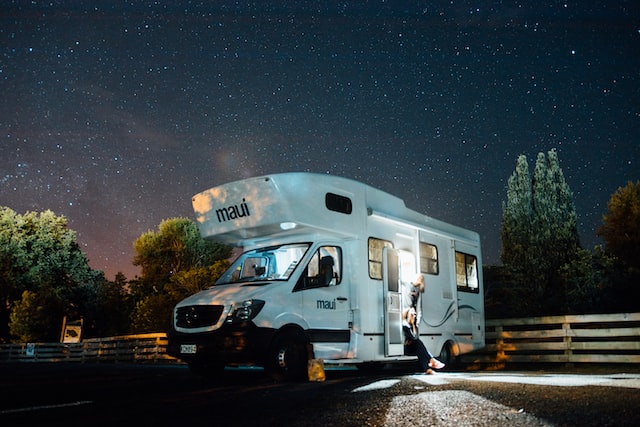 A white RV and a girl getting down.