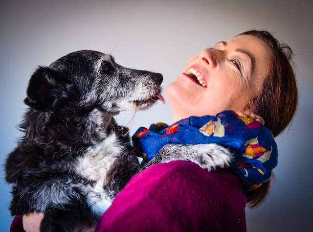 A woman cuddling her dog.