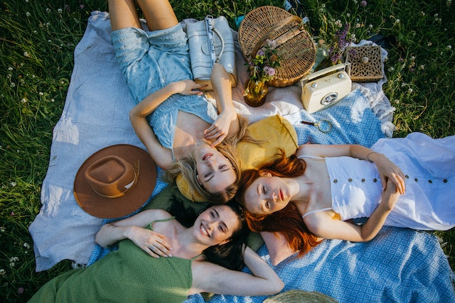 Women lying down on the grass.