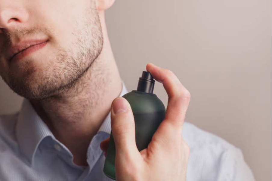 Man spraying perfume.